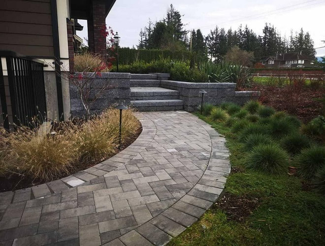multicolored paver walkway, leading to stone staircase